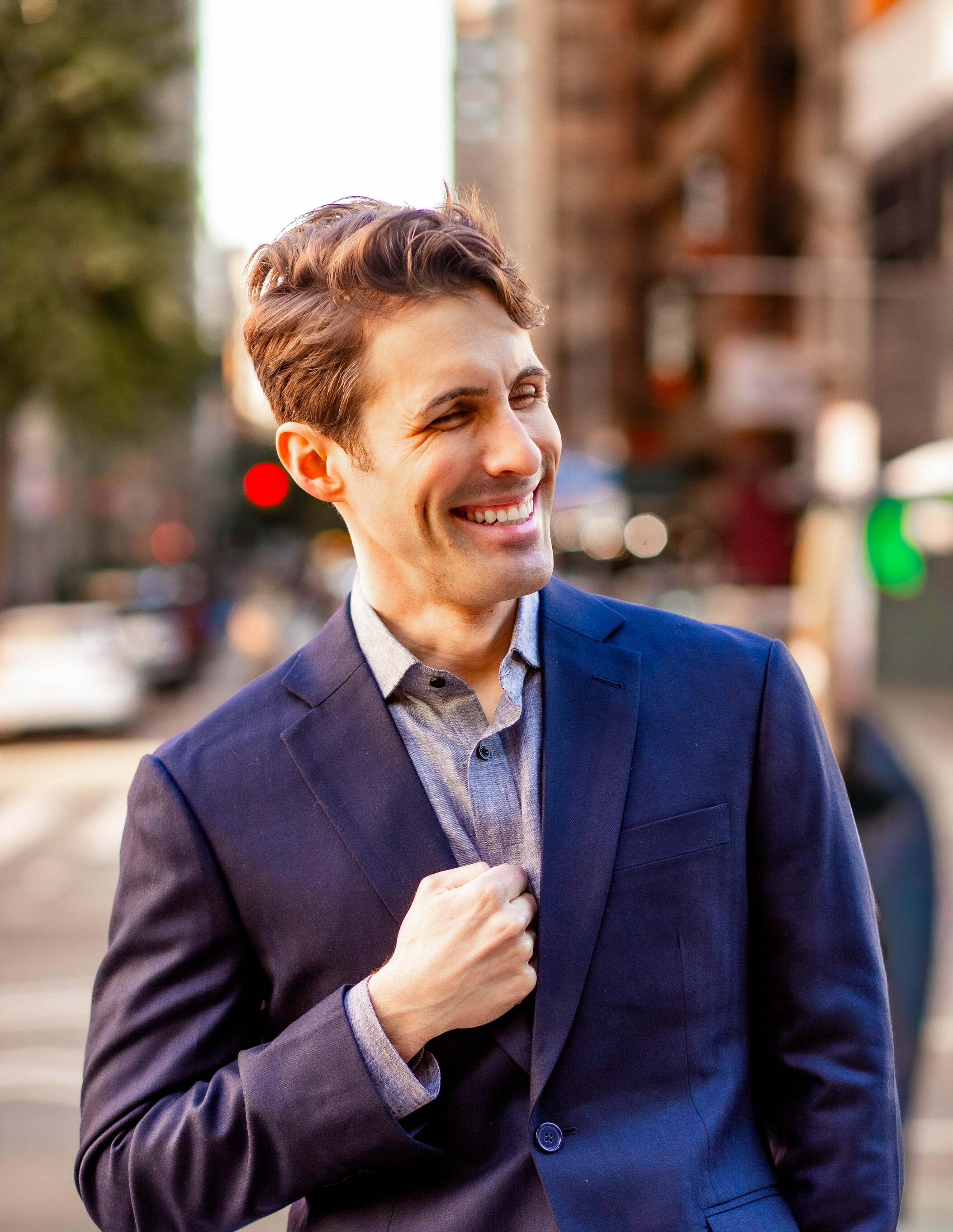 Image of Corey Birnstengel smiling in a suit, standing outside